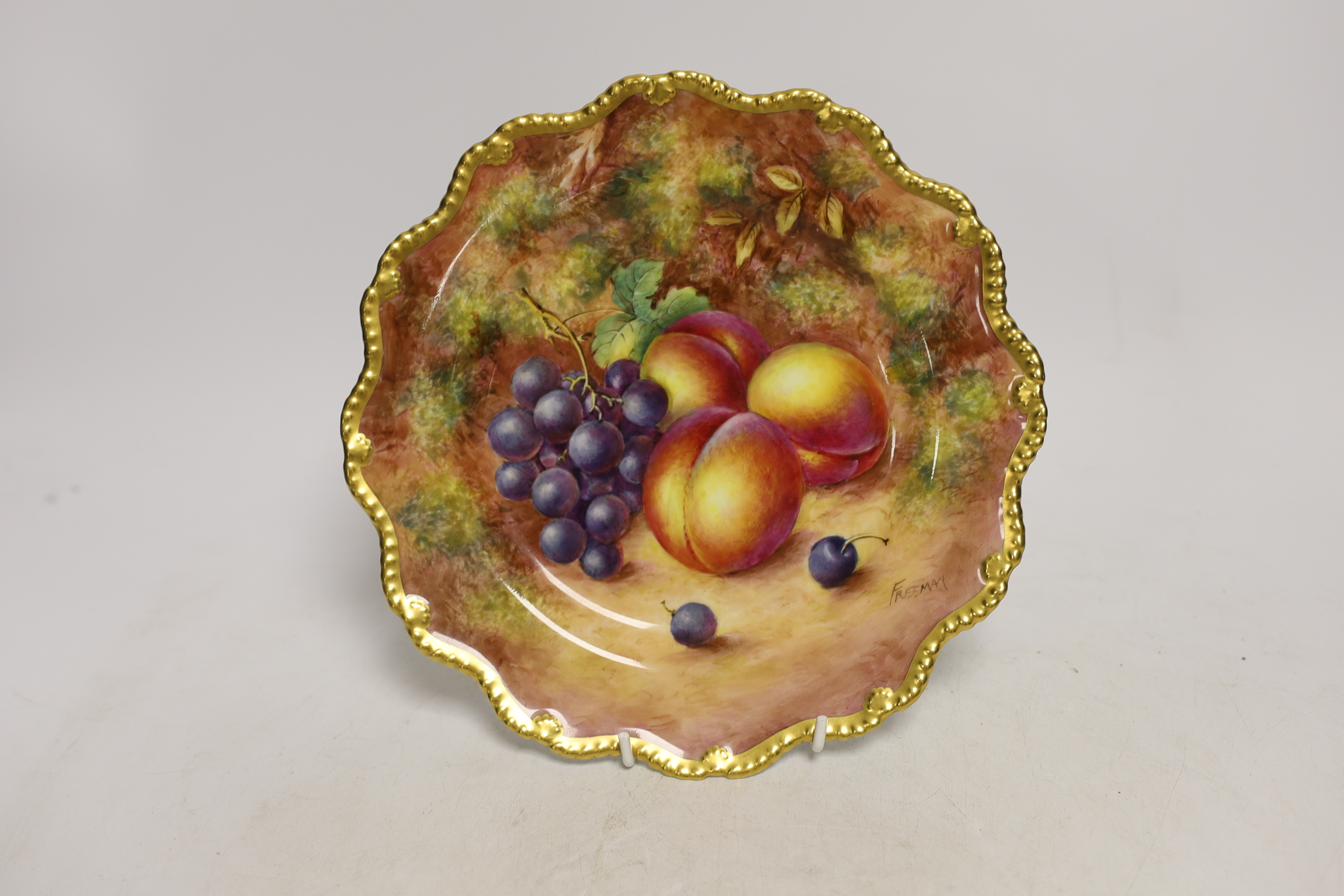A pair of Royal Worcester fruit painted plates, post war, signed Freeman, 22.5cm